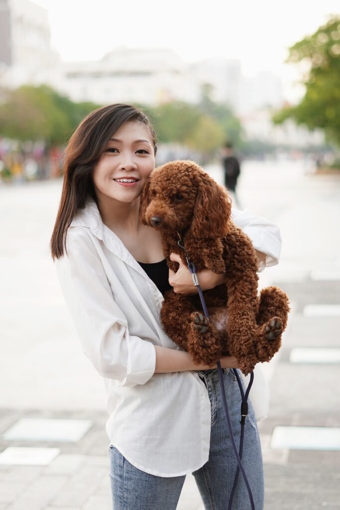 A young woman playing with her dog with smiling 